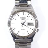 SEIKO 5 - a stainless steel automatic wristwatch, silvered dial with baton hour markers and day date