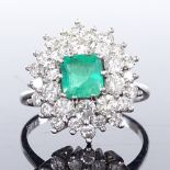 An 18ct white gold emerald and diamond cluster cocktail ring, emerald approx 1.2ct, total diamond