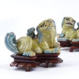 A pair of Chinese glazed porcelain Dogs of Fo, on original carved rosewood stands, length 14cm