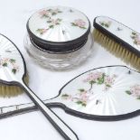 A 4-piece silver and coloured enamel dressing table set, comprising powder jar, hand mirror and 2