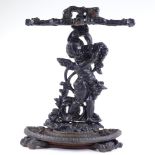 A cast-iron stick stand with cherub support