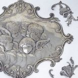 An Edwardian silver book mount set, with relief embossed cherubs and foliate surround, by William