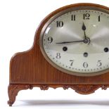 An early 20th century carved walnut-cased 8-day striking mantel clock with silvered dial, height