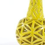 A yellow glazed reticulated pottery vase, unsigned, height 33cm