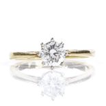 An 18ct gold 0.66ct solitaire diamond ring, setting height 7mm, size O, 3.2g