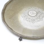 A large George III circular silver salver/tray, with gadrooned rim and 4 claw and ball feet,