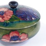 Moorcroft Pottery, circular anemone pattern pot and cover, original paper label, diameter 14cm