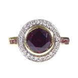 An 18ct gold garnet and diamond cluster ring, with pink tourmaline shoulders, setting height 13.2mm,
