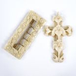 A 19th century relief-carved Dieppe ivory cross pendant, length 7.5cm, and a floral carved ivory