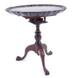 A miniature mahogany tilt-top table on carved tripod base, 30cm across