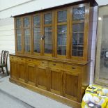 An early 20th century mahogany library bookcase with leadlight glaze panelled cupboards above,