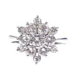 An 18ct white gold diamond cluster snowflake ring, total diamond content approx 1.2ct, setting