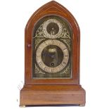 An Edwardian mahogany-cased lancet-top mantel clock, with brass and silvered dial and 8-day