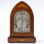 An Edwardian mahogany and marquetry inlaid lancet-top mantel clock, with engraved silvered dial