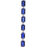 A 14ct white gold sapphire and diamond tennis line bracelet, set with 20 emerald-cut sapphires, each