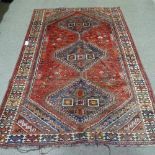 A large handmade red ground wool rug, with animal decoration and floral border, 250cm x 165cm