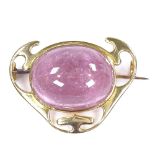 An Arts and Crafts 15ct gold cabochon pink tourmaline brooch, with pierced settings, tourmaline