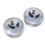 A pair of circular silver pillboxes, with Scottish thistle design hardstone set lids, by William