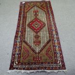 A long red ground Tabriz wool rug, with geometric border, 220cm x 100cm
