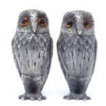 A modern pair of heavy gauge silver novelty owl salt and pepper pots, with realistic feather