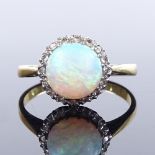 An 18ct gold cabochon opal and diamond cluster ring, setting height 10.2mm, size K, 2.5g