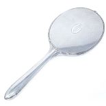 A large sterling silver dressing table hand mirror, with gadrooned border and engine turned