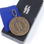A German SS Four Year Service medal, boxed