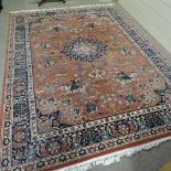 A Turkish red ground Schiraz rug, with central hunting scene and deity border, 350cm x 250cm