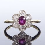 An 18ct gold ruby and diamond cluster flowerhead ring, setting height 11.2mm, size O, 2.5g