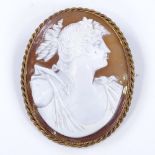 A relief carved cameo shell panel brooch/pendant, depicting Classical female portrait, in 9ct gold