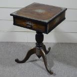 An Indian hardwood side table with brass mounts, drawer and tripod base