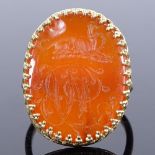 A large unmarked gold carnelian intaglio seal ring, with greyhound emblem and initials MB, setting