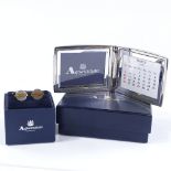 Aquascutum, chrome plated new and boxed perpetual calendar and photo frame, together with new and