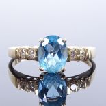 A 14ct gold blue topaz and diamond dress ring, setting height 8mm, size P, 2.3g