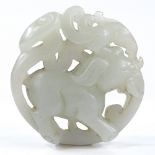 A Chinese carved and pierced nephrite elephant design disc pendant, 5cm across