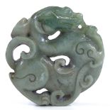 A Chinese carved and pierced jadeite dragon design disc pendant, 5.5cm across