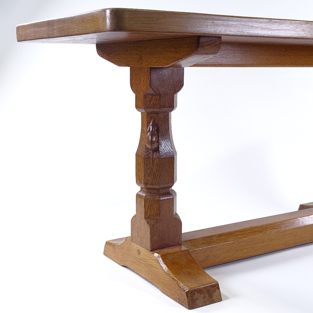 Robert Thompson (Mouseman), a golden oak stretcher table with carved end column supports and