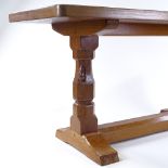 Robert Thompson (Mouseman), a golden oak stretcher table with carved end column supports and