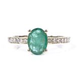 A 14ct gold solitaire emerald ring, with diamond set shoulders, oval-cut emerald approx 0.71ct,