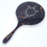 A tortoiseshell and silver pique inlaid dressing table hand mirror, indistinct maker's marks,