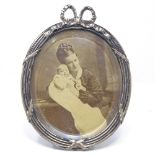 A Danish oval silver-fronted photo frame, with bow decoration and kick stand, by S&M Benzen, overall