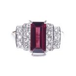 A 9ct white gold red tourmaline and diamond stepped dress ring, setting height 11.4mm, size N, 4.1g