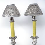 A pair of Sheffield plate candlesticks with patent candle holders, and a pair of Eastern silver