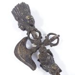 A 19th century Tibetan bronze Thurba, with relief-cast mask decorated handle, length 29cm