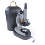 A Russian-made student's microscope in metal carrying case