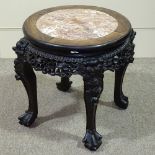 A Chinese 19th century carved hardwood low table, with inset marble top and carved and pierced