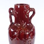 A Claymout Massier red glaze ceramic 2-handled vase, with relief moulded designs, height 50cm