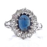 An 18ct white gold sapphire and diamond cluster ring, oval-cut sapphire approx 1.3ct, total