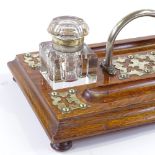 A Victorian oak desk stand with electroplate mounts and glass inkwells, width 30cm