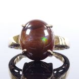 A 9ct gold cabochon brown ammolite dress ring, with pierced shoulders and bridge, setting height